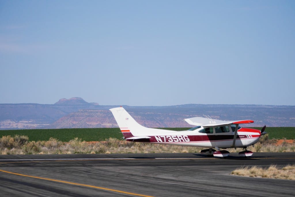 The Bears Ears can be seen in the background as participants prepare to depart the Blanding airport for an overflight of the area.